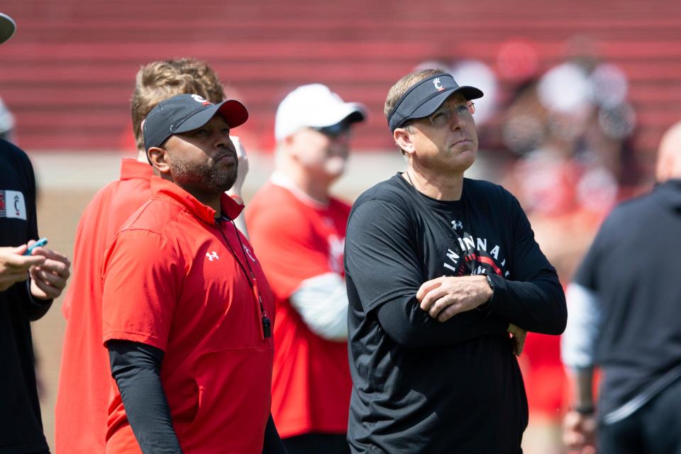 Cincinnati Bearcats head coach Scott Satterfield talks to associate head coach and defensive coordinator Bryan Brown during the Cincinnati Bearcats spring scrimmage at Nippert Stadium on Saturday, April 15, 2023.