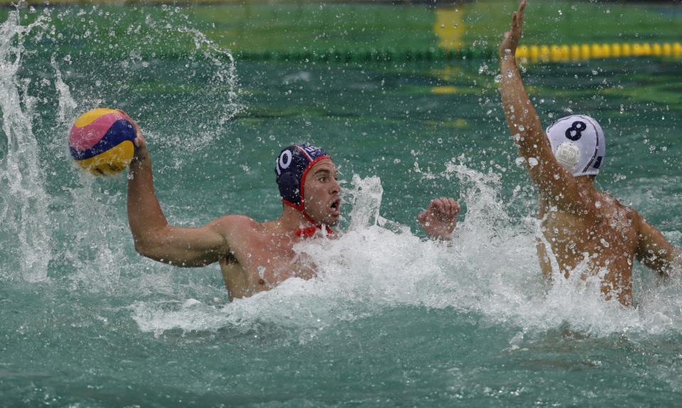 Bret Bonanni of the U.S. men's water polo team takes a shot against France in Rio's green water. (Getty)