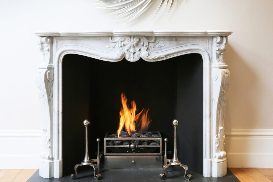 Marble fireplace lit with fire