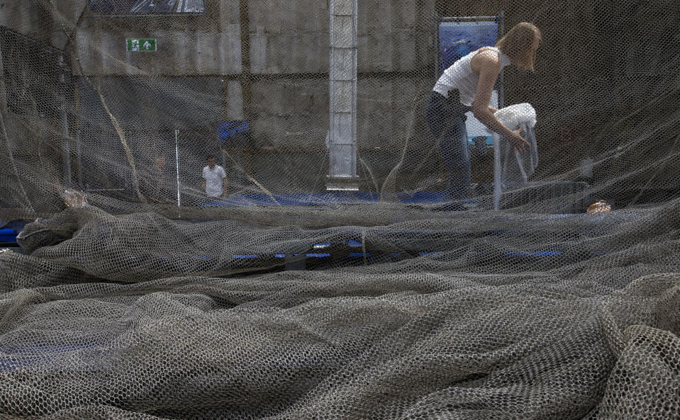 People prepare for the press conference of the Ocean Cleanup foundation in Utrecht, Netherlands, Thursday, May 11, 2017. The foundation aiming to rid the world's oceans of plastic says it will start cleaning up the huge patch of floating junk known as the Great Pacific Garbage Patch within the next 12 months, two years ahead of schedule. (AP Photo/Peter Dejong)