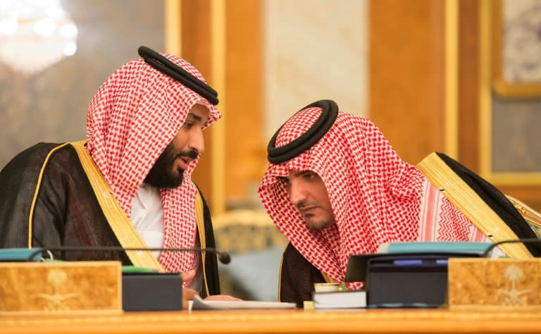 This handout picture provided by the Saudi Royal Palace on July 10, 2017, shows Saudi Crown Prince Mohammed bin Salman speaking with Interior Minister Prince Abdelaziz bin Saud bin Nayef during a cabinet meeting in Mecca