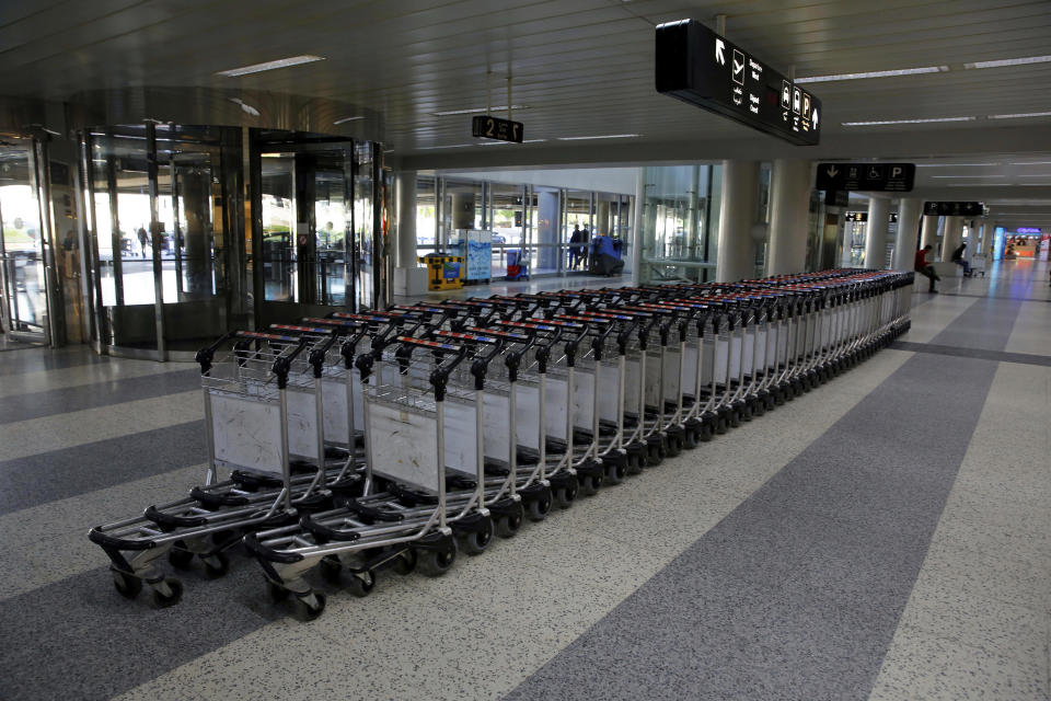 Airport trollies lined in the almost empty arrival hall of the Rafik Hariri International Airport during a strike in Beirut, Lebanon, Friday, Jan. 4, 2019. Parts of Lebanon's public and private sectors have gone into a strike called for by the country's labor unions to protest worsening economic conditions and months of delays in the formation of a new government. (AP Photo/Bilal Hussein)