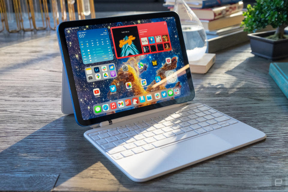 Das iPad der 10. Generation auf einem Tisch im Freien mit angeschlossenem Magic Keyboard.

