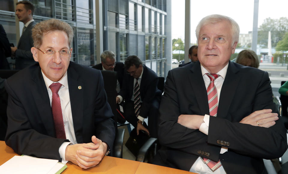 Hans-Georg Maassen, left, head of the German Federal Office for the Protection of the Constitution, and German Interior Minister Horst Seehofer, right, arrive for a hearing at the home affairs committee of the German federal parliament, Bundestag, in Berlin, Germany, Wednesday, Sept. 12, 2018. (AP Photo/Michael Sohn)