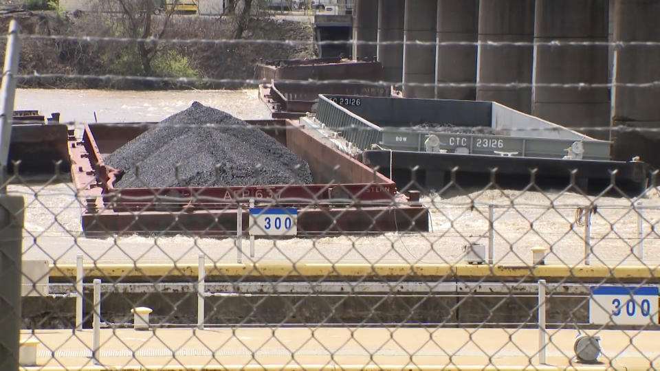 A group of barges sit pinned against the Emsworth lock and dam in Pittsburgh, on Saturday, April 13, 2024. More than two dozen river barges broke loose from their moorings and floated down the Ohio River, damaging a marina and striking a bridge. (WTAE via AP)