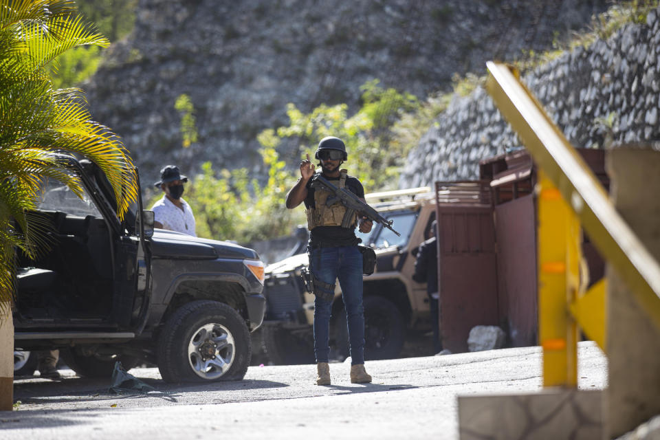 Presidential guards patrol the entrance to the residence of late Haitian President Jovenel Moise in Port-au-Prince, Haiti, Wednesday, July 7, 2021. Moïse was assassinated in an attack on his private residence early Wednesday, and first lady Martine Moïse was shot in the overnight attack and hospitalized, according to a statement from the country’s interim prime minister. (AP Photo/Joseph Odelyn)