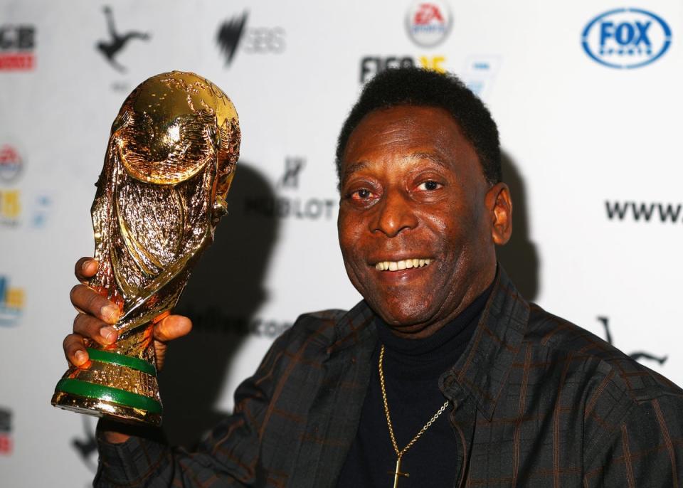 Pele holds a replica World Cup trophy during a press conference in Melbourne in 2015 (Getty)
