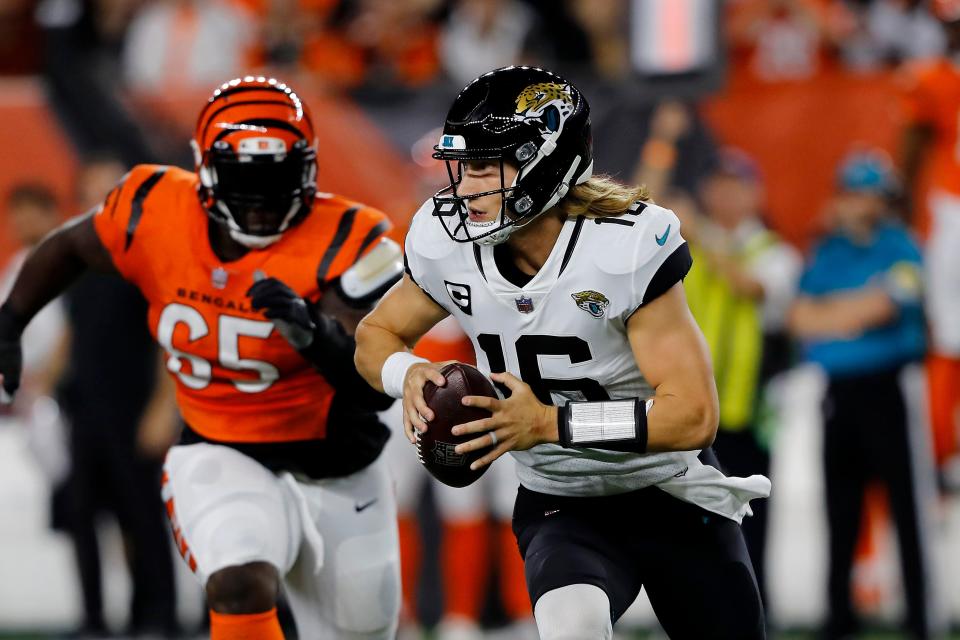 Sep 30, 2021; Cincinnati, Ohio, USA; Jacksonville Jaguars quarterback Trevor Lawrence (16) moves out to pass during the first quarter against the Cincinnati Bengals at Paul Brown Stadium. Mandatory Credit: Joseph Maiorana-USA TODAY Sports