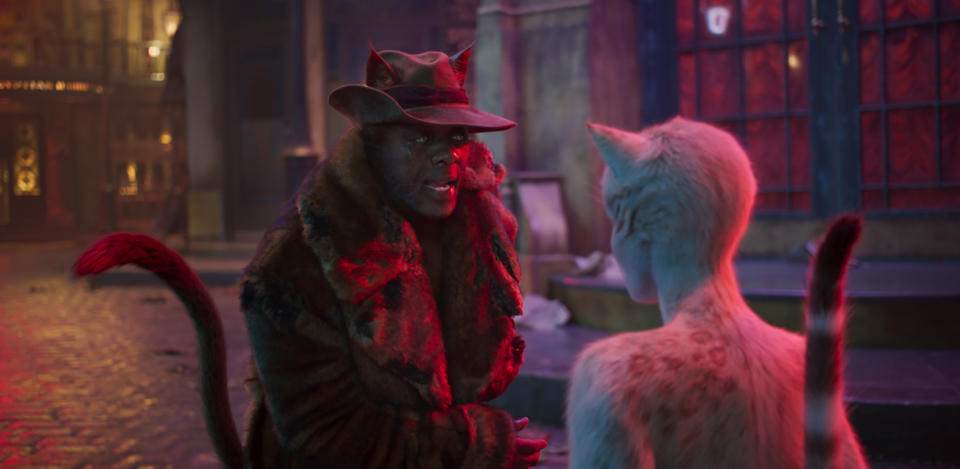 This image released by Universal Pictures shows Idris Elba as Macavity, left, and Francesca Hayward as Victoria in a scene from "Cats." (Universal Pictures via AP)