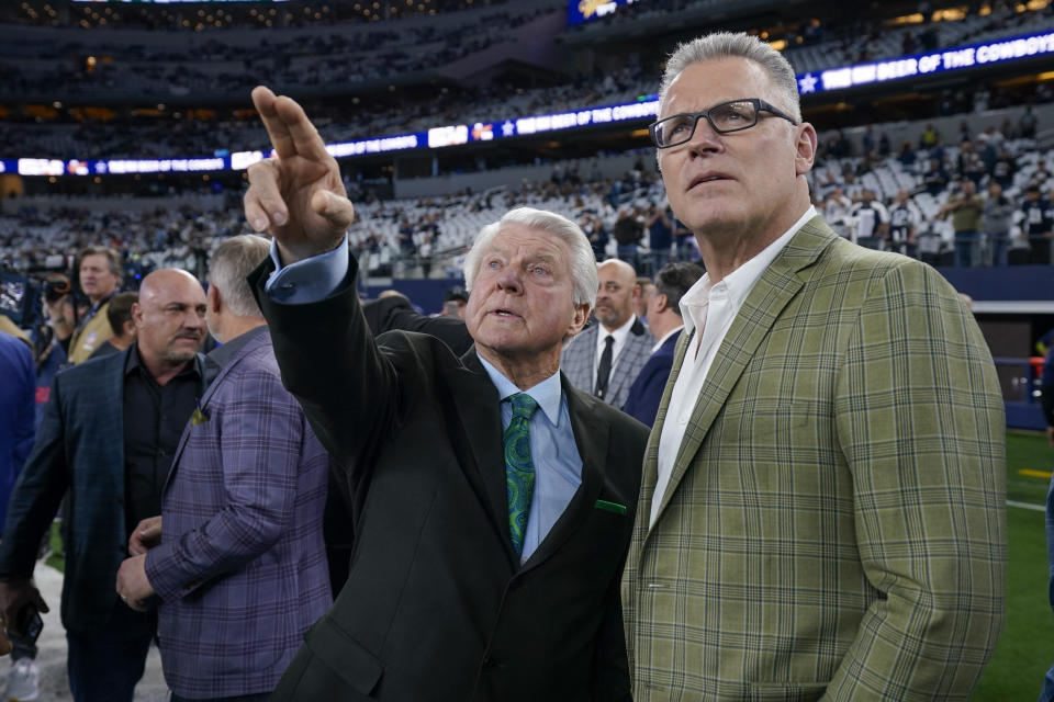 Pro Football Hall of Fame coach Jimmy Johnson, left, talks with former NFL player Howie Long prior to an NFL football game between the Dallas Cowboys and the Detroit Lions, Saturday, Dec. 30, 2023, in Arlington, Texas. Johnson will be inducted into the team's ring of honor during a halftime ceremony. (AP Photo/Sam Hodde)