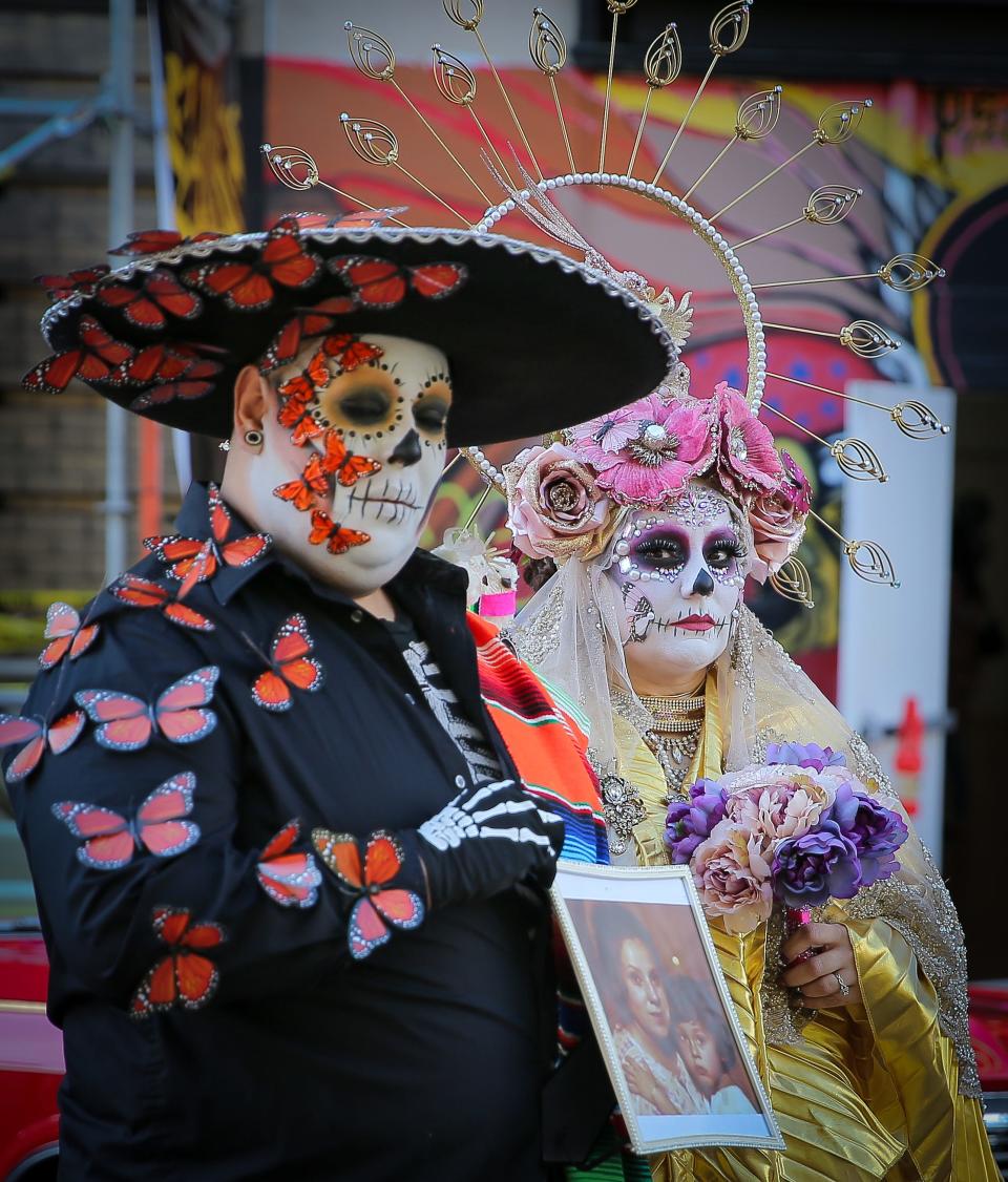 Two revelers take in the Dia de los Muertos at the Mexican Heritage Center in downtown Stockton.