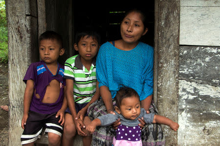 Claudia Maribel Maquin, mother of Jakelin, a 7-year-old girl who died in U.S. custody, stands with her other children outside her house in Raxruha, Guatemala December 15, 2018. REUTERS/Josue Decavele