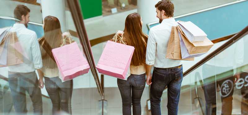 A couple on an escalator at a shopping mall