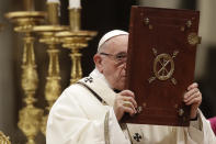 Pope Francis holds the book of the Gospels as he celebrates the Christmas Eve Mass in St. Peter's Basilica at the Vatican, Monday, Dec. 24, 2018. (AP Photo/Alessandra Tarantino)