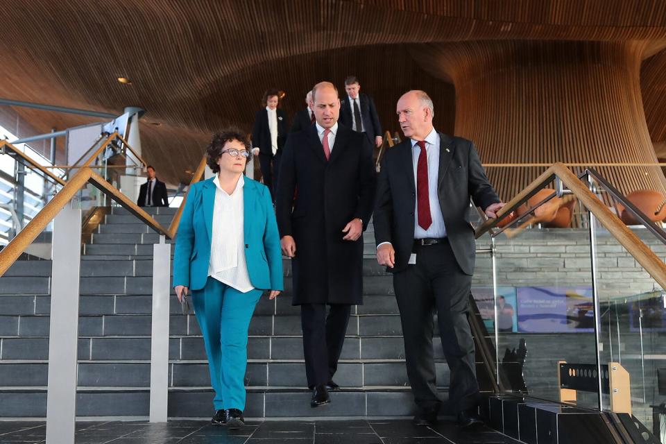 Prince William (C), Prince of Wales, walks with Senedd members Elin Jones (L) and David Rees during a visit to the Senedd, the Welsh Parliament, in Cardiff