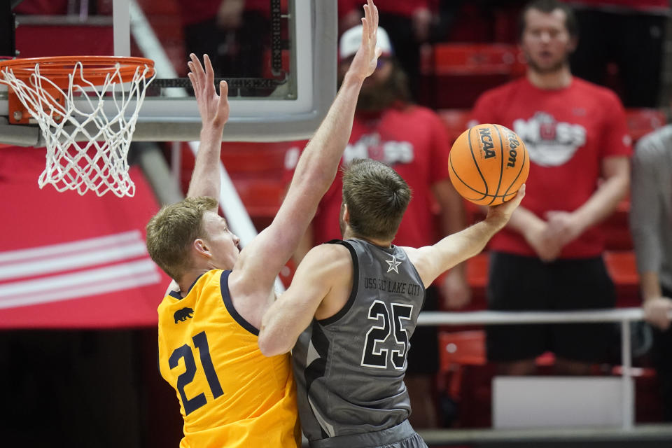Utah guard Rollie Worster (25) goes to the basket as California forward Lars Thiemann (21) defends during the first half of an NCAA college basketball game Sunday, Feb. 5, 2023, in Salt Lake City. (AP Photo/Rick Bowmer)