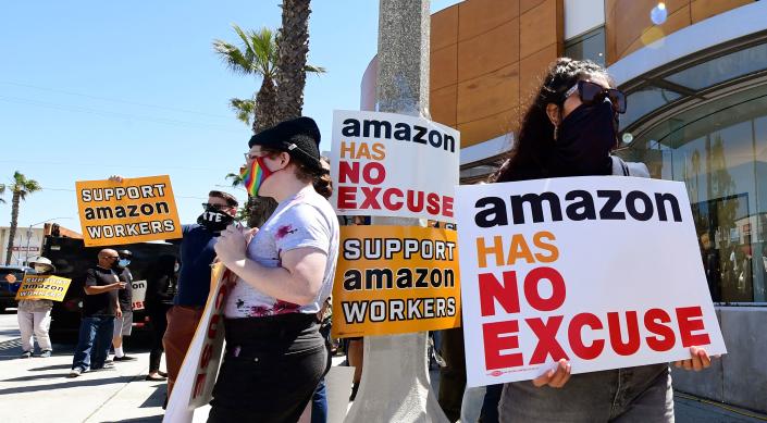 Supporters of Amazon workers protest in front of Fidelity Investments, one of the company&#39;s largest shareholders on May 24, 2021 in Santa Monica, California. - The nationwide protests are asking shareholders to demand that Amazon change its practices to be more accountable to workers, communities and stakeholders, while also calling on Amazon to cut ties with US Immigration and Customs Enforcement and end its anti-competitive monopoly practices. (Photo by Frederic J. BROWN / AFP) (Photo by FREDERIC J. BROWN/AFP via Getty Images)