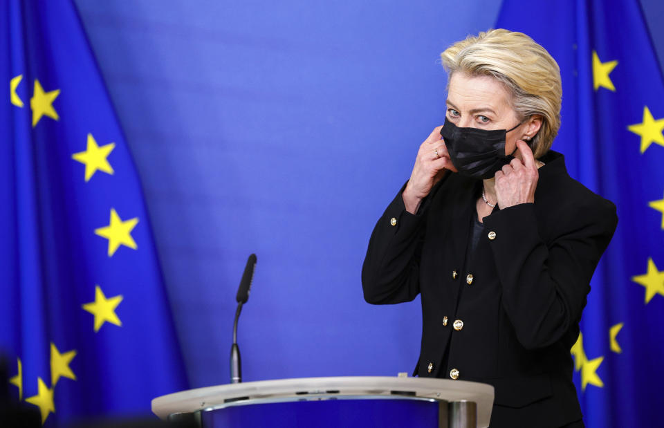 European Commission President Ursula von der Leyen removes her protective mask prior to making a statement, regarding the death of European Parliament President David Sassoli, at EU headquarters in Brussels, Tuesday, Jan. 11, 2022. David Sassoli, the Italian journalist who worked his way up in politics and became president of the European Union's parliament, died at a hospital in Italy early Tuesday, Jan. 11, 2022 his spokesperson said. (AP Photo/Olivier Matthys, Pool)