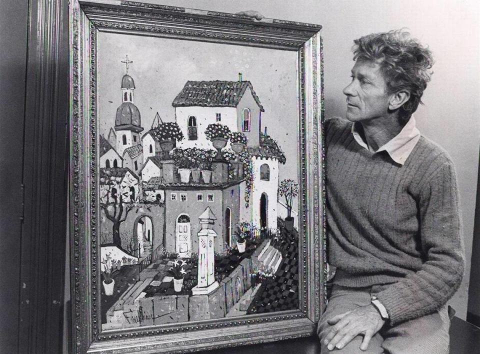 Henry Faulkner with one of his paintings on March 30, 1977.