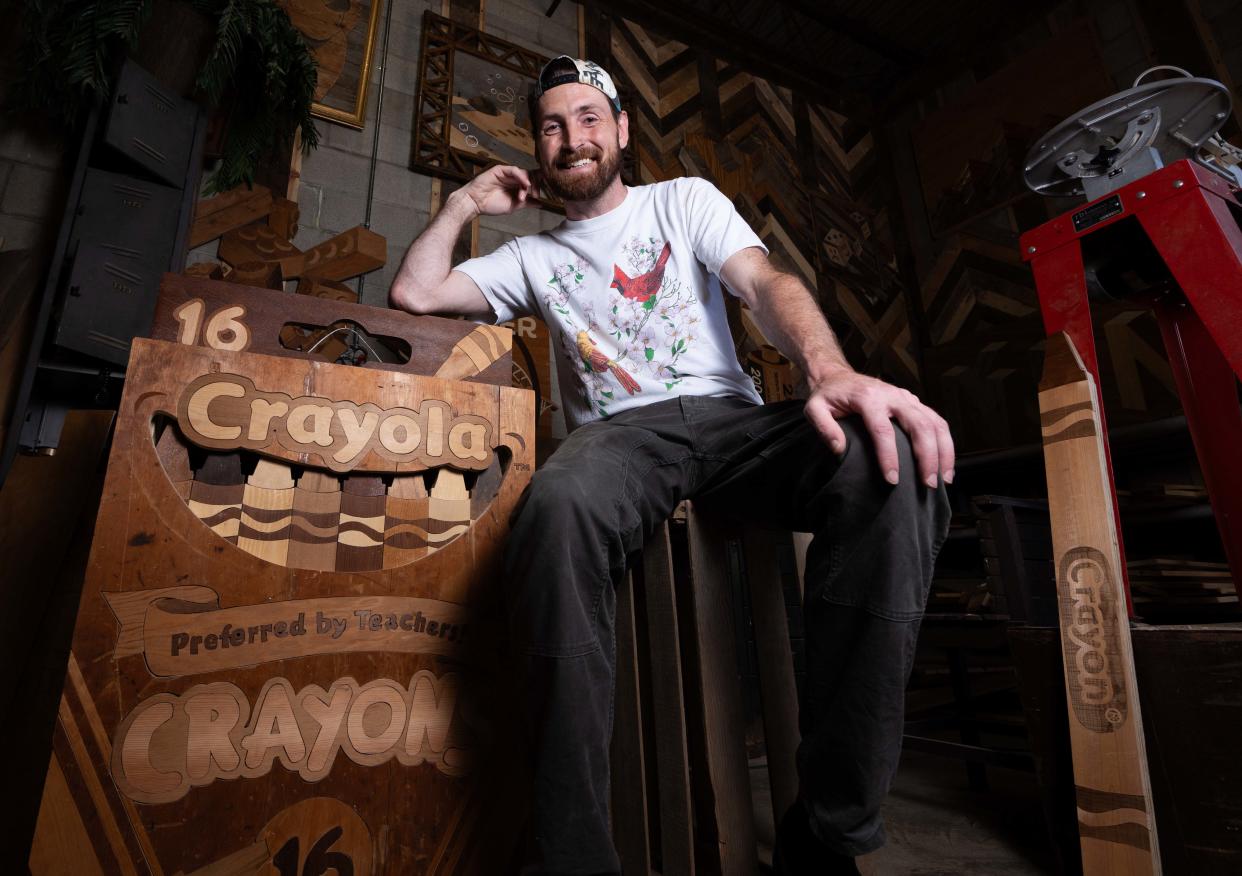 Wisconsin wood artist Ike Wynter, who uses discarded wood to make art that focuses on nostalgia and mental health awareness, poses for a portrait on Wednesday, June 12, 2024, in Butler, Wisconsin.