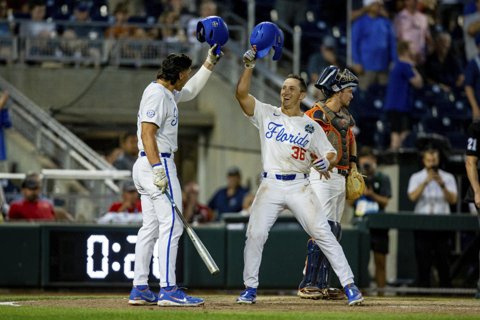 Florida batter Wyatt Langford (36) celebrates after his home run with Jac Caglianone in the ninth inning of a baseball game against Virginia at the NCAA College World Series in Omaha, Neb., Friday, June 16, 2023. (AP Photo/John Peterson)