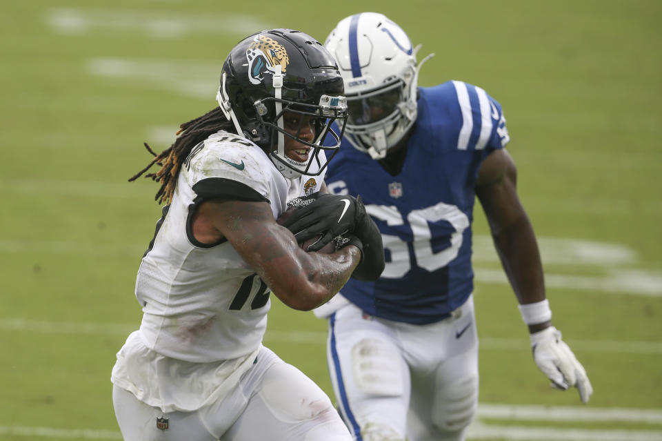 Jacksonville Jaguars wide receiver Laviska Shenault Jr., left, scores a touchdown on a 16-yard pass play in front of Indianapolis Colts defensive end Justin Houston during the first half of an NFL football game, Sunday, Sept. 13, 2020, in Jacksonville, Fla. (AP Photo/Stephen B. Morton)