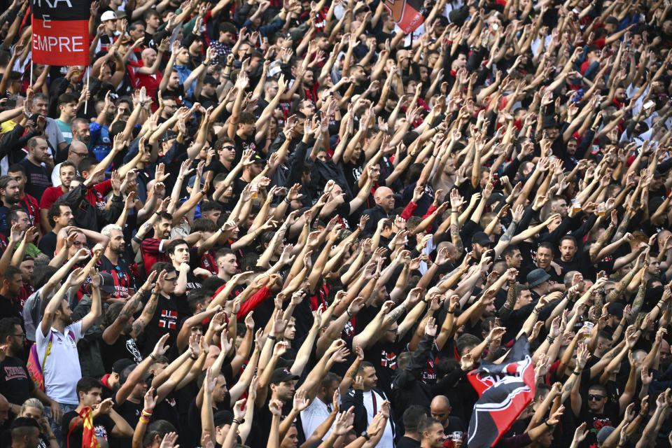 Fans of AC Milan cheer during the Serie A soccer match between Sassuolo and Milan at Mapei Stadium, Reggio Emilia, Italy, Tuesday Aug. 30, 2022. (Massimo Paolone/LaPresse via AP)