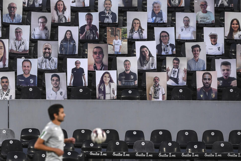 Photos of Vitoria supporters are placed on the empty stands prior to the Portuguese League soccer match between Vitoria SC and Sporting CP in Guimaraes, Portugal, Thursday, June 4, 2020. The Portuguese League soccer matches resumed Wednesday without spectators because of the coronavirus pandemic. (Hugo Delgado/Pool via AP)