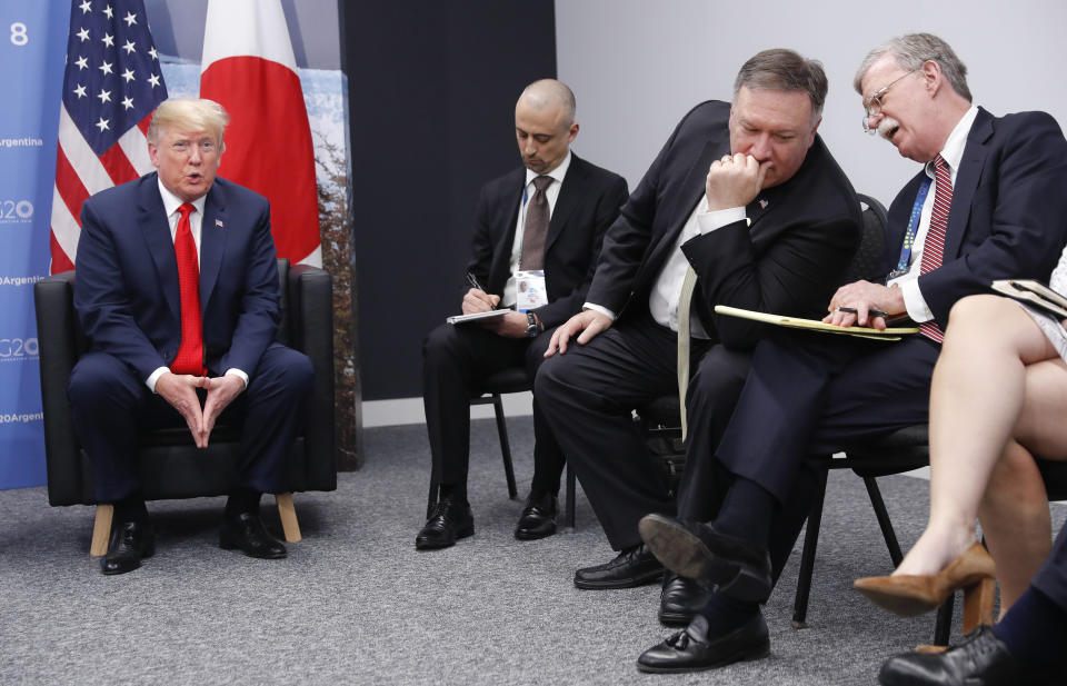 Secretary of State Mike Pompeo, second from the right, confers with National Security Adviser John Bolton, far right, as President Donald Trump, left, answers questions from members of the media during a meeting with Japan’s Prime Minister Shinzo Abe, Friday, Nov. 30, 2018 in Buenos Aires, Argentina. (Photo: Pablo Martinez Monsivais/AP)