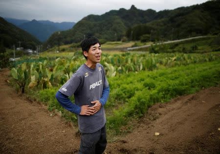 26 year-old farmer Yohka Tanaka speaks at his field in Nanmoku Village, northwest of Tokyo, Japan October 12, 2017. REUTERS/Issei Kato