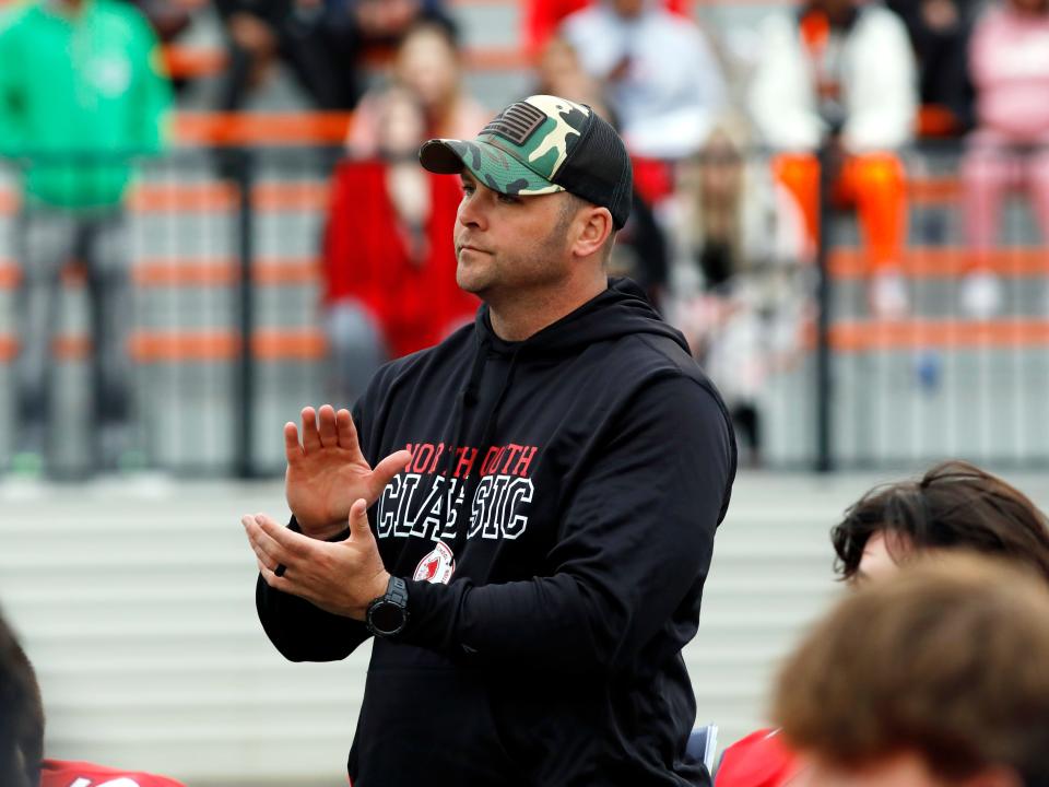 West Muskingum head coach Nathan Brownrigg listens to the postgame speech following the South's 27-18 loss to the North in the Division IV-VII game of the annual Ohio North-South Football Classic on Saturday at Paul Brown Stadium in Massillon. Brownrigg served as an assistant under Van Wert's Keith Recker.