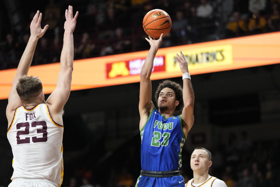 Florida Gulf Coast guard Dallion Johnson (23) attempts a shot as Minnesota forward Parker Fox (23) defends during the second half of an NCAA college basketball game Saturday, Dec. 9, 2023, in Minneapolis. (AP Photo/Abbie Parr)