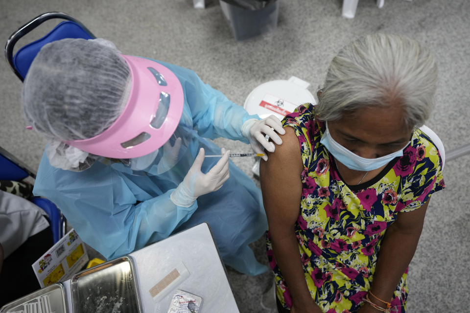 A health worker administers a shot of the AstraZeneca COVID-19 vaccine at the Central Vaccination Center in Bangkok, Thailand, Thursday, July 22, 2021. (AP Photo/Sakchai Lalit)