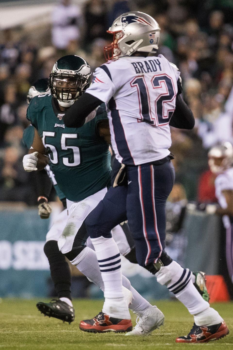Eagles' Brandon Graham (55) eyes New England's Tom Brady (12) during a 2019 game between the two teams. Graham is most known for his strip-sack of Brady late in the Eagles 41-33 win over New England in the Super Bowl on Feb. 4, 2018.