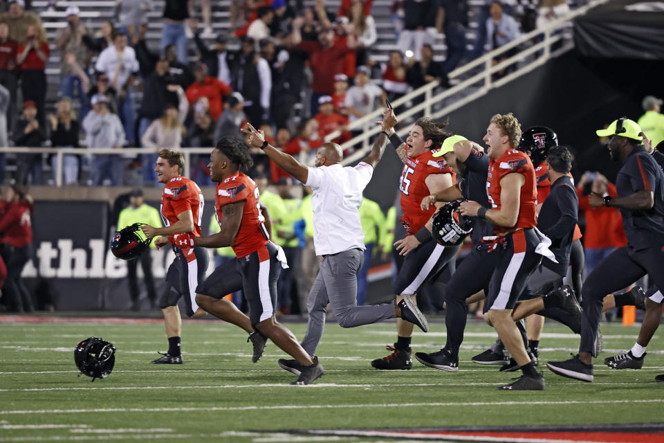 Texas Tech athletes and coaches run onto the field after an NCAA college football game against Iowa State, Saturday, Nov. 13, 2021, in Lubbock, Texas. (AP Photo/Brad Tollefson)