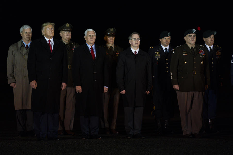 President Donald Trump and Vice President Mike Pence watches as a U.S. Army carry team salutes the transfer case's containing the remains of Sgt. 1st Class Javier Gutierrez, of San Antonio, Texasa and Sgt. 1st Class Antonio Rodriguez, of Las Cruces, N.M., Monday, Feb. 10, 2020, at Dover Air Force Base, Del. According to the Department of Defense both died Saturday, Feb. 8, during combat in Afghanistan. (AP Photo/Evan Vucci)