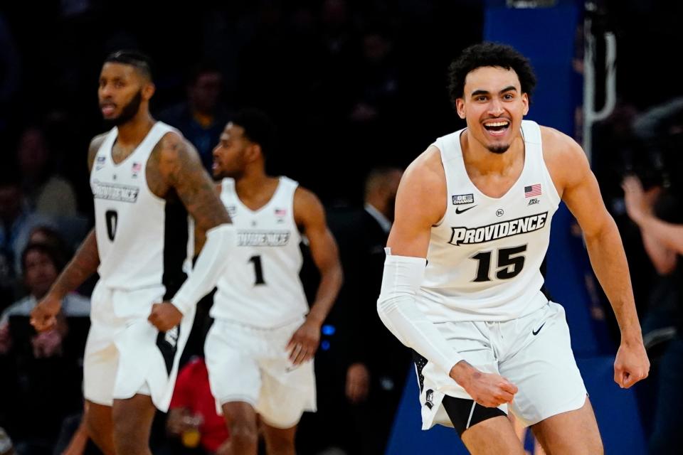 Providence's Justin Minaya (15) celebrates with teammates after an NCAA college basketball game against Butler at the Big East conference tournament Thursday, March 10, 2022, in New York. Providence won 65-61. (AP Photo/Frank Franklin II)