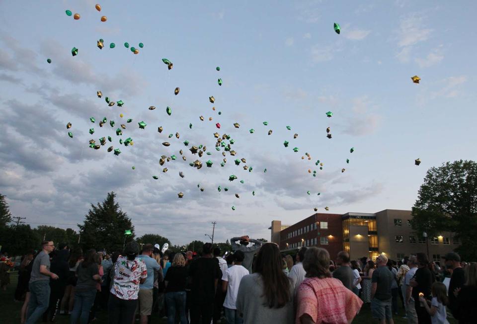 Balloons are released from the Firestone High School baseball field following a vigil for Ethan Liming, 17, a much loved and admired Firestone student who played baseball and football. Liming was killed in an altercation near the basketball courts at the I Promise School on Thursday night.