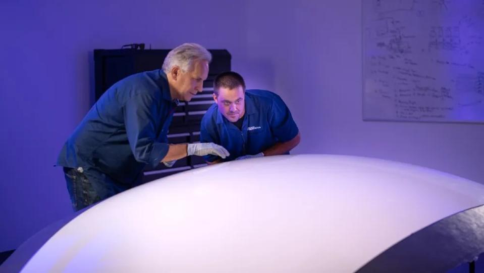 CEO MacCallum and lead engineer Peter Tinkham working on an early prototype of the capsule.