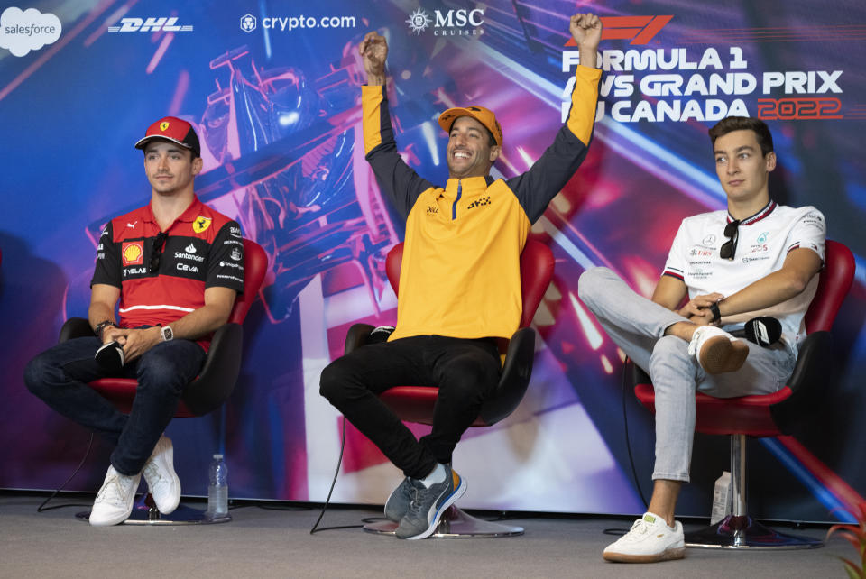 McLaren F1 Team driver Daniel Ricciardo, of Australia, reacts next to Scuderia Ferrari driver Charles Leclerc, left, of Monaco and Mercedes Team British driver George Russell during a news conference at the Canadian Grand Prix Friday, June 17, 2022, in Montreal. (Paul Chiasson/The Canadian Press via AP)