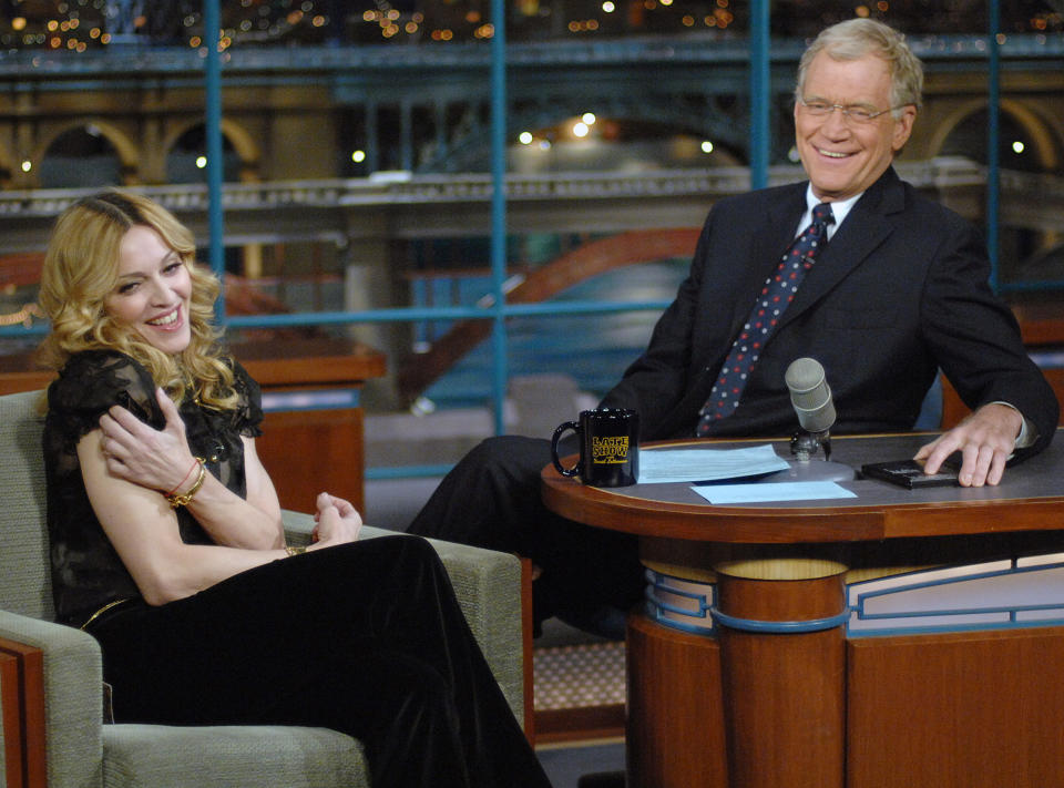 FILE - In this Jan. 11, 2006 file photo released by CBS, Madonna joins host David Letterman on the set of "The Late Show with David Letterman," in New York. Madonna was in town to attend a special screening of "Arthur and The Invisibles." Letterman announced his retirement during a taping on Thursday, April 3, 2014. Although no specific date was announced he told the audience that he will leave his desk sometime in 2015. (AP Photo/CBS, J P Filo, File) MANDATORY CREDIT; NO SALES; NO ARCHIVE; NORTH AMERICAN USE ONLY