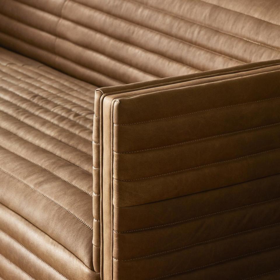 Shown in Cognac, the Padma sofa’s horizontal channels are hand-sewn