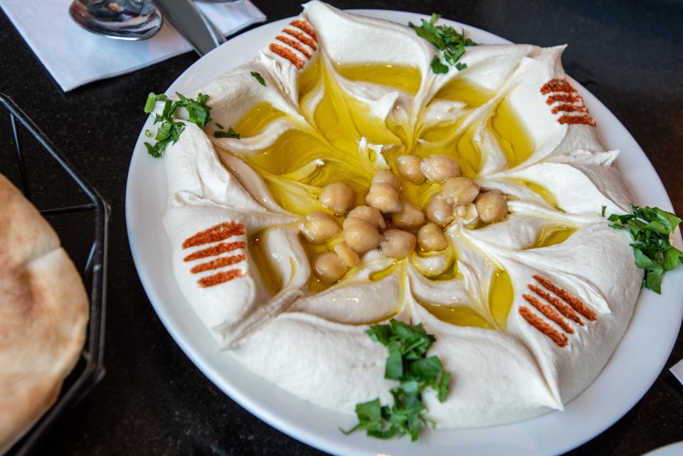 Paterson mayor André Sayegh and NorthJersey food editor Esther Davidowitz tour Paterson on a Palestinian food crawl on Tuesday July 19, 2022. A plate of hummus is shown at Al-Basha.