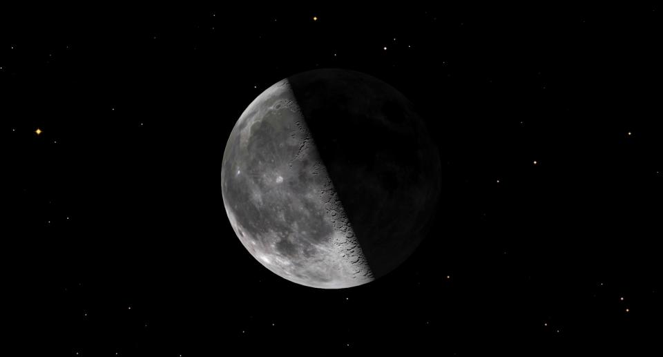 A large quarter moon hangs centrally in the starry sky, with its shadow half on the right.