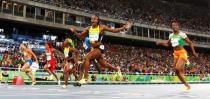 2016 Rio Olympics - Athletics - Final - Women's 100m Final - Olympic Stadium - Rio de Janeiro, Brazil - 13/08/2016. Elaine Thompson (JAM) of Jamaica (2nd R) wins the women's 100m final. REUTERS/Kai Pfaffenbach