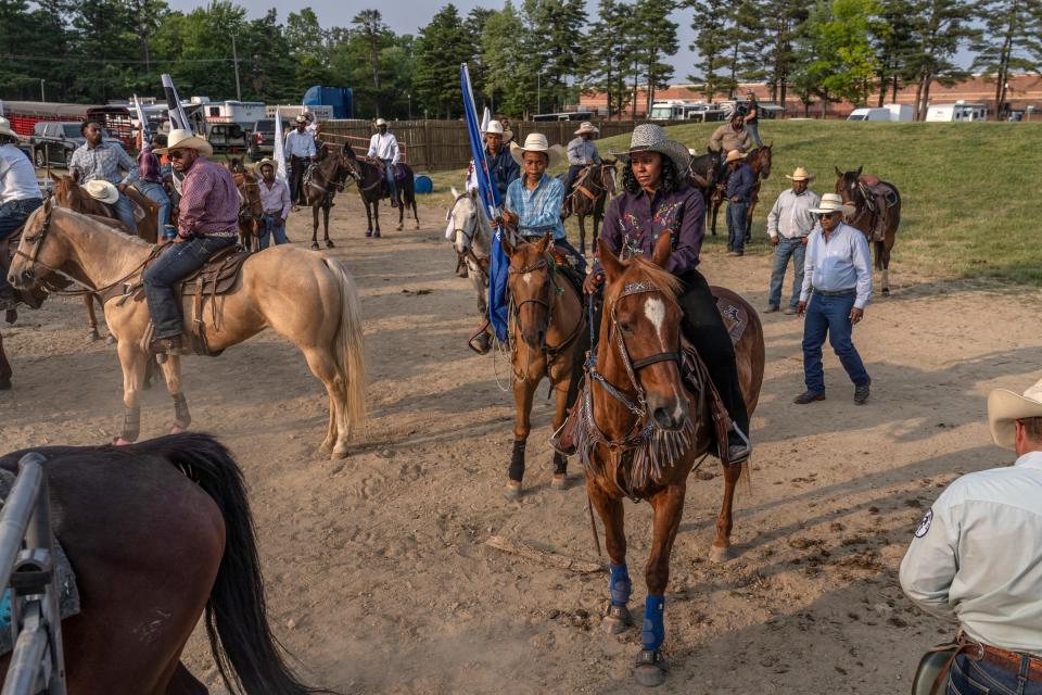 Staci Russell, 39, of Belleville, sits atop her horse, Reese's Cup, before taking part in the opening ceremony during the second day of the 2023 Midwest Invitational Rodeo at the Wayne County Fairgrounds in Belleville on Saturday, June 10, 2023.