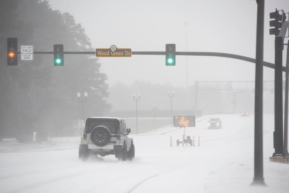 A few adventurous drivers make their way along MS Hwy. 463 in Madison, Miss., early morning Monday, Feb. 15, 2021, after a winter storm moved through the area Sunday, Feb. 14, 2021.