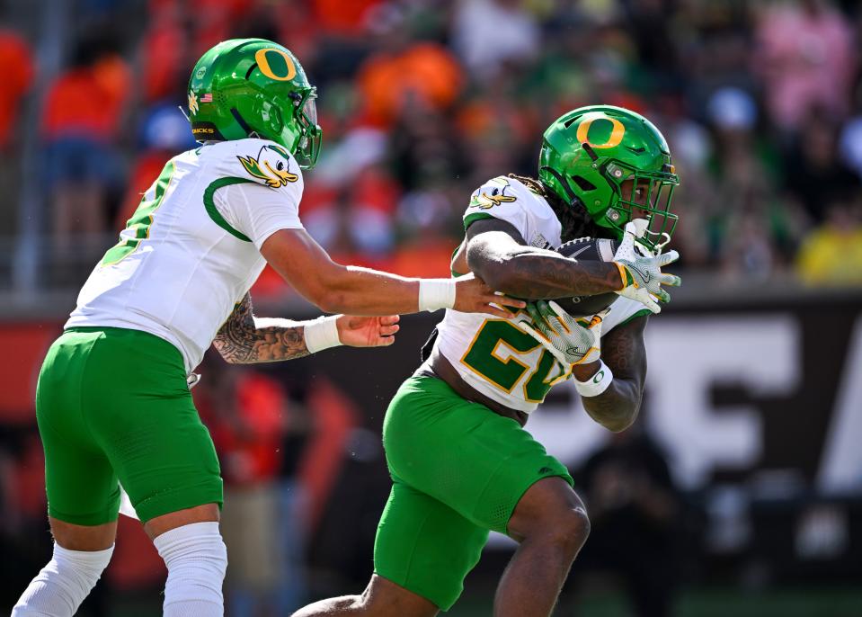 Oregon Ducks quarterback Dillon Gabriel (8) hands off the ball to Oregon Ducks running back Jordan James (20) during the annual rivalry game against the Oregon State Beavers on Saturday, Sept. 14, 2024 at Reser Stadium in Corvallis, Ore.