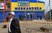 Colombian police and soldiers guard a supermarket supposedly linked to FARC in Bogota, Colombia February 21, 2018. REUTERS/Jaime Saldarriaga