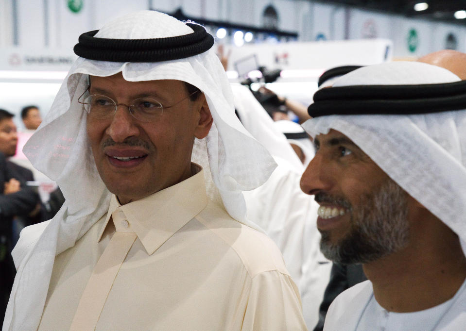 Saudi Arabia's new Energy Minister Prince Abdulaziz bin Salman, left, and United Arab Emirates Energy Minister Suhail al-Mazrouei, right, walk through an energy exhibition in Abu Dhabi, United Arab Emirates, Monday, Sept. 9, 2019. Prince Abdulaziz, as well as the CEOs of Total SA and ENI SpA, were in Abu Dhabi on Monday at the World Energy Congress. (AP Photo/Jon Gambrell)